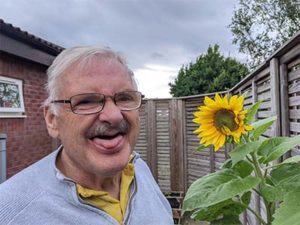 Mike next to a sunflower he grew
