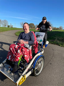 man in a wheelchair platform bike