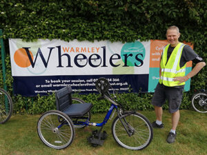 A man standing next to a bicycle