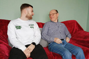 Two men sitting on a sofa