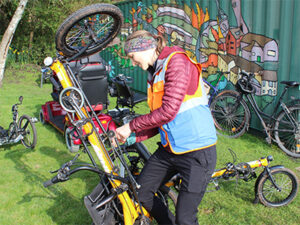 A woman fixing a bicycle